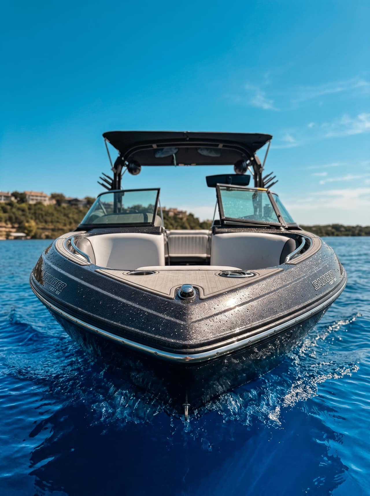 Guest wakesurfing behind the Sanger V237 SX with a shaped wake on Lake Austin